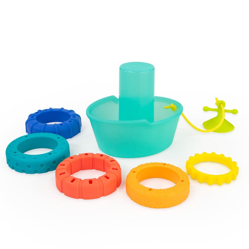 Stackin’ Ship bath toy pieces laid out, including the turquoise boat and coloured rings