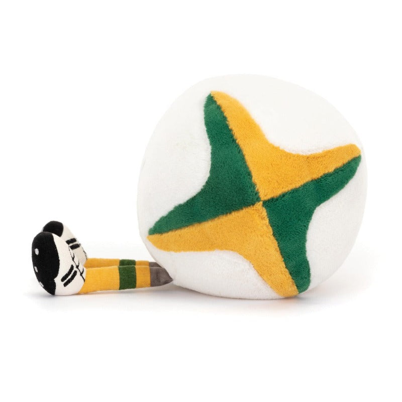 Jellycat Amuseable Sports Australian Rugby Ball side view — white plush rugby ball with green and gold cross panel design on end, with green and gold striped rugby sock and black studded boot visible at side