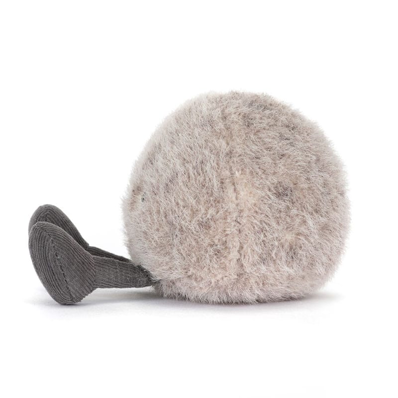 Jellycat Amuseables Pebble side view — round grey plush pebble with fluffy textured fur and dark grey corduroy feet, showing slim disc-like profile