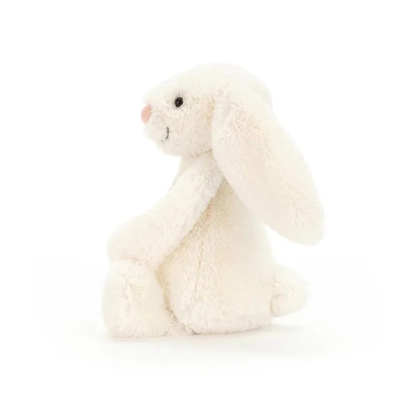 Jellycat Bashful Cream Bunny Medium front view — soft cream plush bunny with long floppy ears, embroidered pink nose, black bead eyes and fluffy textured fur, sitting soft toy