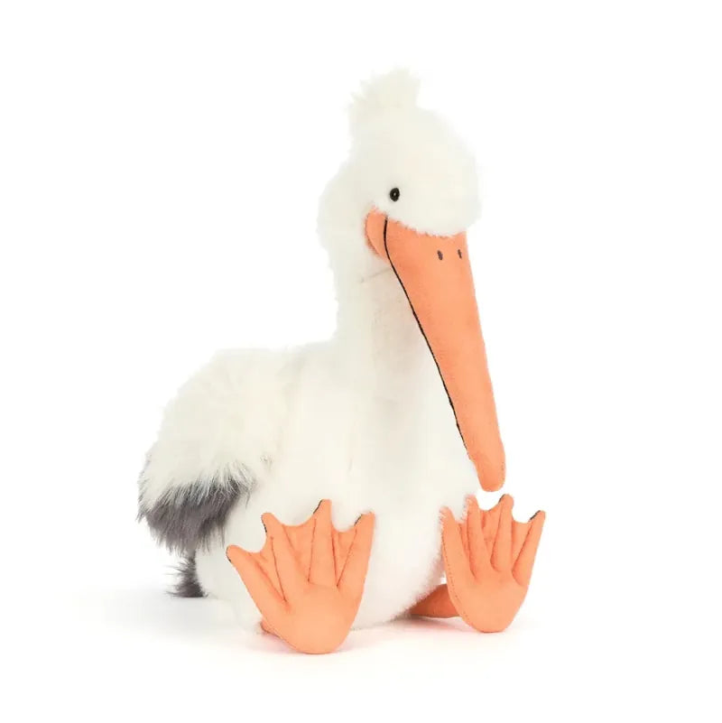 Jellycat Keli Pelican front view — white and grey plush pelican with large orange beak pouch, black wingtips, orange webbed feet and embroidered smiling face