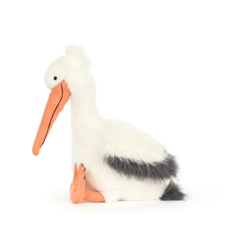 Jellycat Keli Pelican front view — white and grey plush pelican with large orange beak pouch, black wingtips, orange webbed feet and embroidered smiling face