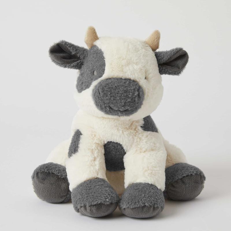 Jiggle & Giggle Bertie Cow plush toy seated facing forward, with cream fur, grey patches, grey hooves and small beige horns