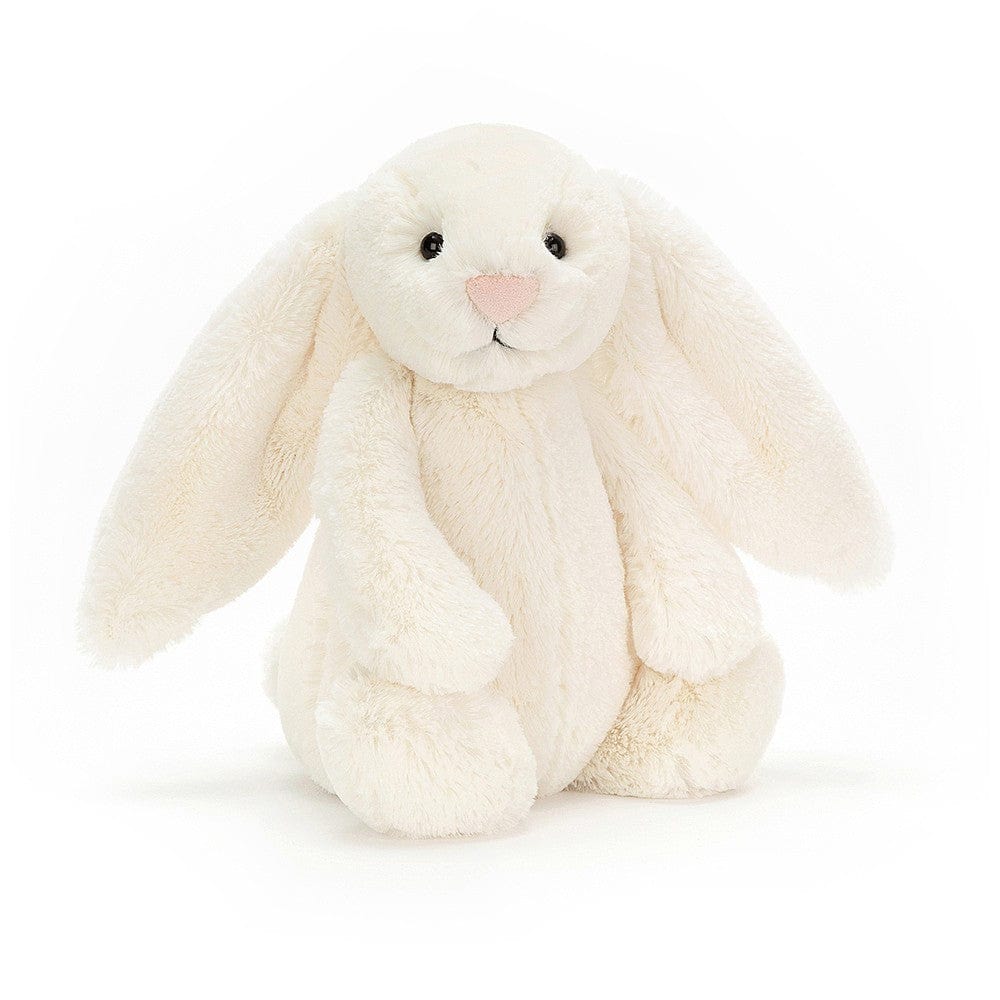 Jellycat Bashful Cream Bunny Medium front view — soft cream plush bunny with long floppy ears, embroidered pink nose, black bead eyes and fluffy textured fur, sitting soft toy