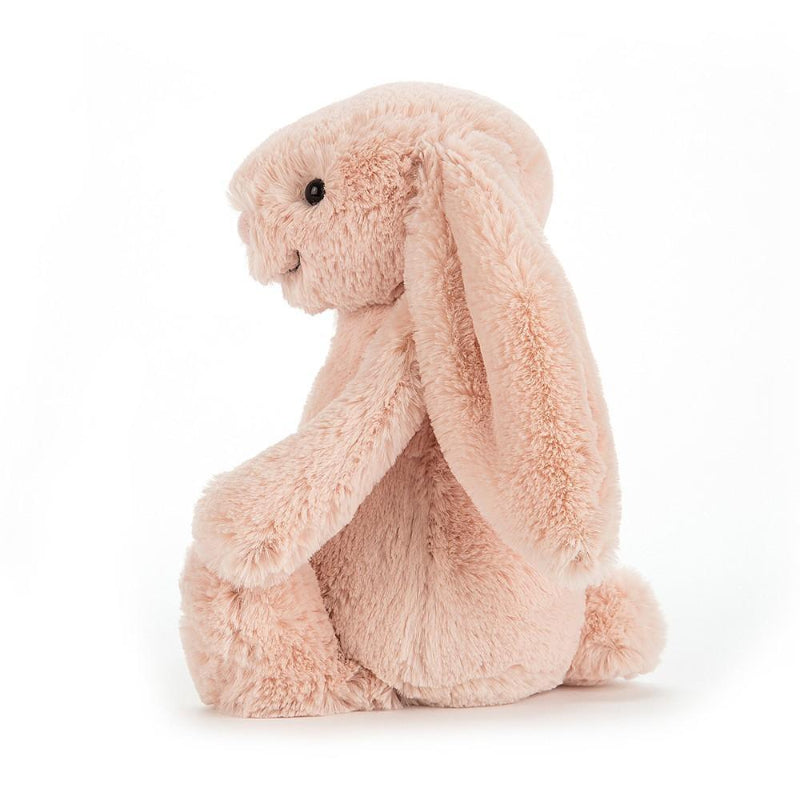 Jellycat Bashful Blush Bunny Medium front view — soft blush pink plush bunny with long floppy ears, embroidered pink nose, black bead eyes and fluffy textured fur, sitting soft toy