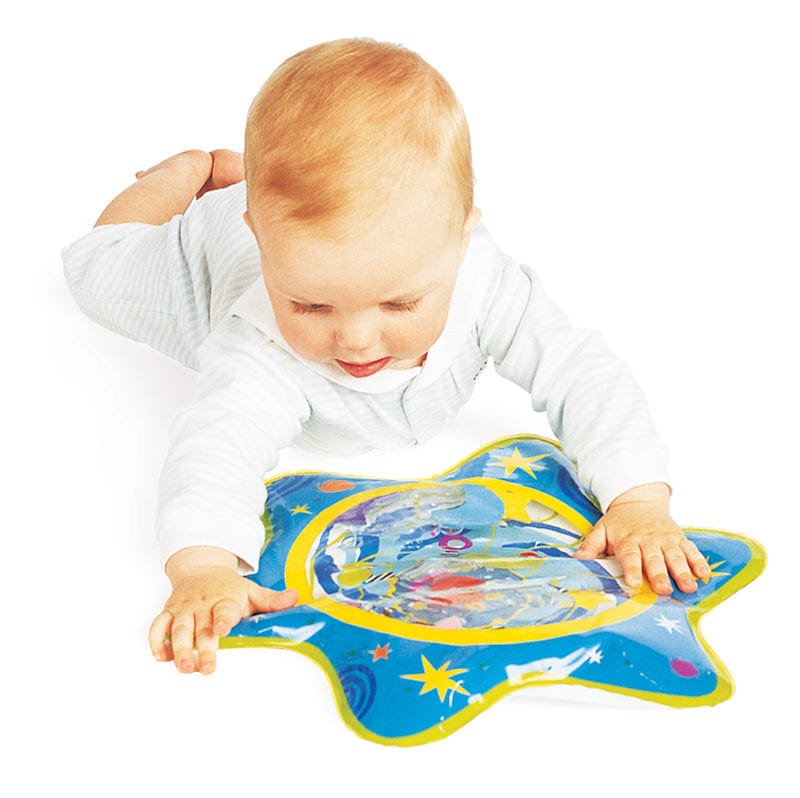 Baby lying on their tummy playing with the Whoozit water mat, reaching for the floating shapes